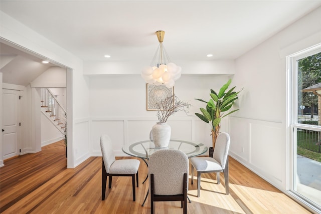 dining space featuring a chandelier and light hardwood / wood-style floors