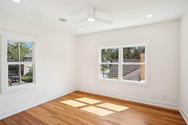 empty room featuring hardwood / wood-style flooring and ceiling fan