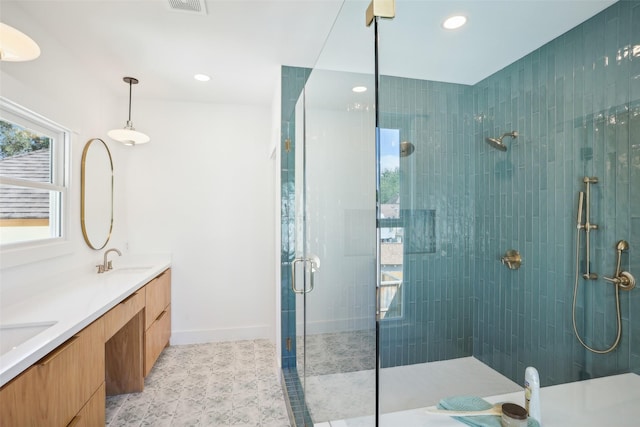 bathroom featuring vanity and a shower with shower door