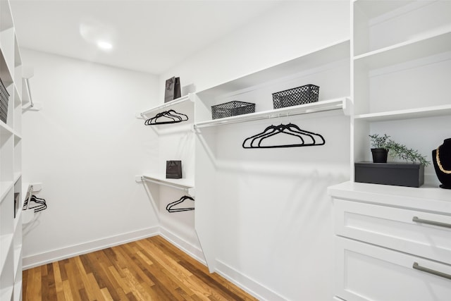 spacious closet featuring hardwood / wood-style floors