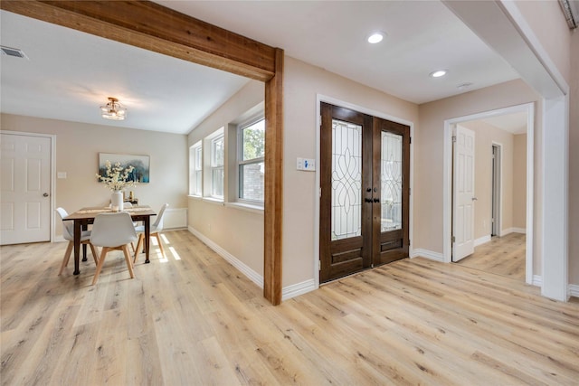 entryway featuring french doors and light hardwood / wood-style flooring