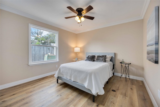 bedroom with ceiling fan, crown molding, and light hardwood / wood-style floors