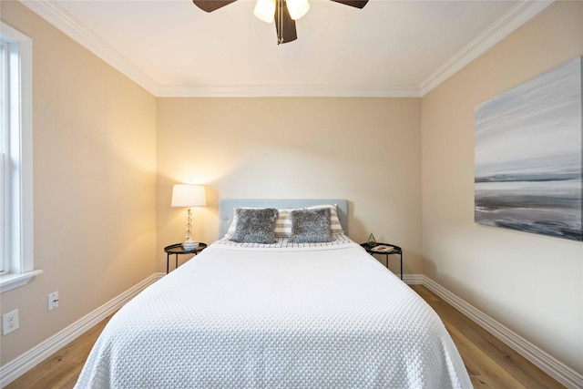 bedroom with ceiling fan, hardwood / wood-style floors, and ornamental molding