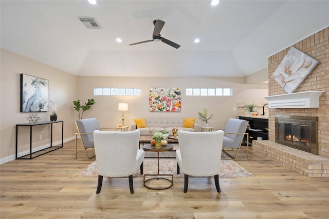 dining space featuring plenty of natural light, a brick fireplace, ceiling fan, and lofted ceiling