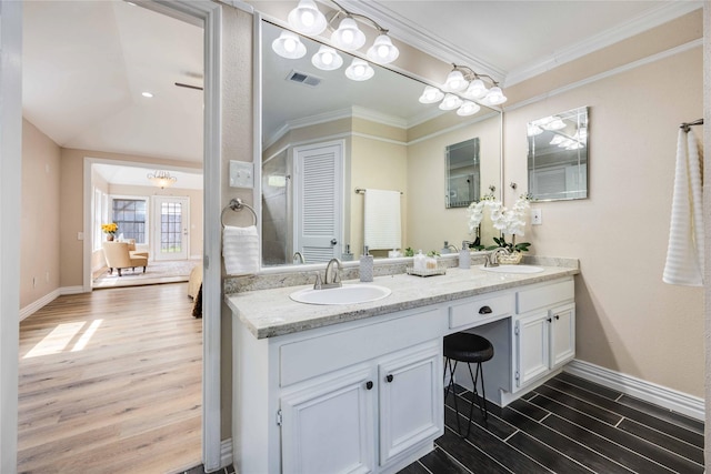 bathroom featuring vanity, ceiling fan, and crown molding