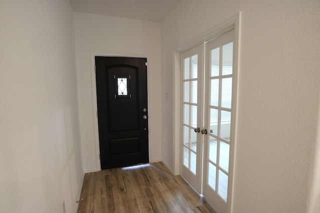 doorway with hardwood / wood-style floors and french doors