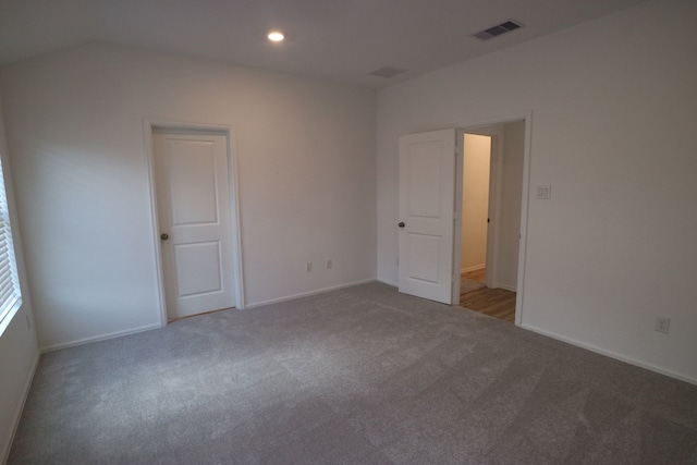 unfurnished room with dark carpet