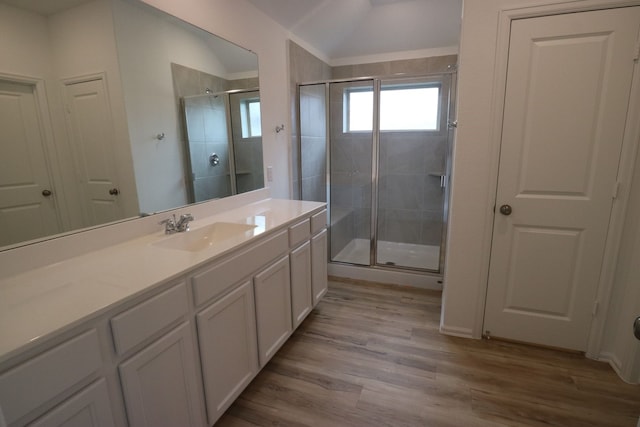 bathroom with vanity, wood-type flooring, and walk in shower