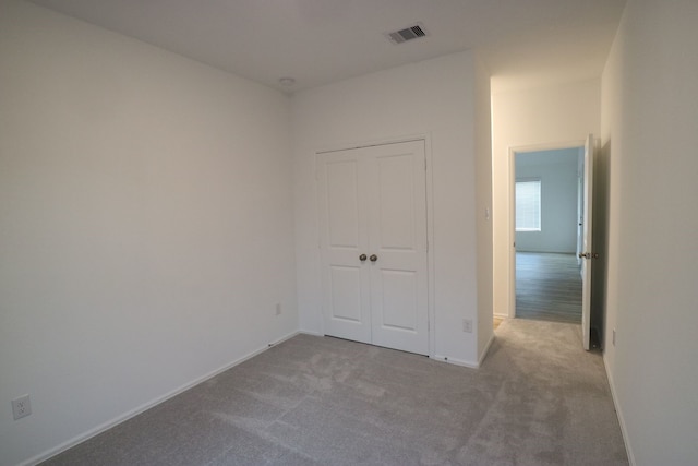 empty room featuring light colored carpet