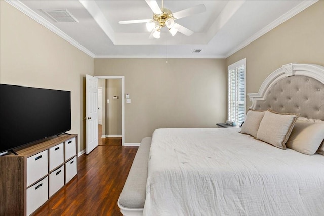 bedroom with a raised ceiling, ceiling fan, dark hardwood / wood-style flooring, and crown molding