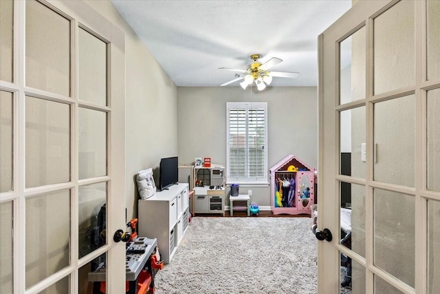 rec room with ceiling fan and french doors