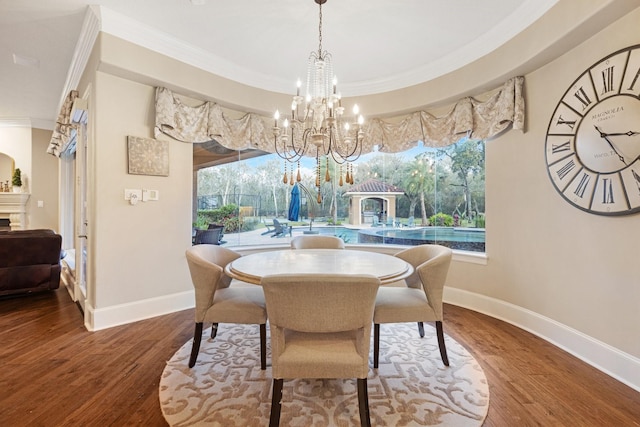 dining area featuring hardwood / wood-style flooring, ornamental molding, and a wealth of natural light