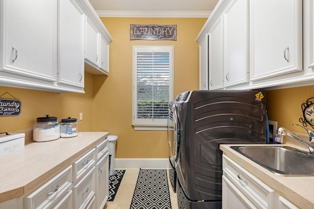 laundry area featuring cabinets, light tile patterned floors, ornamental molding, and sink