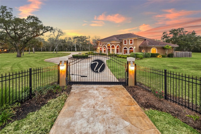 gate at dusk with a yard