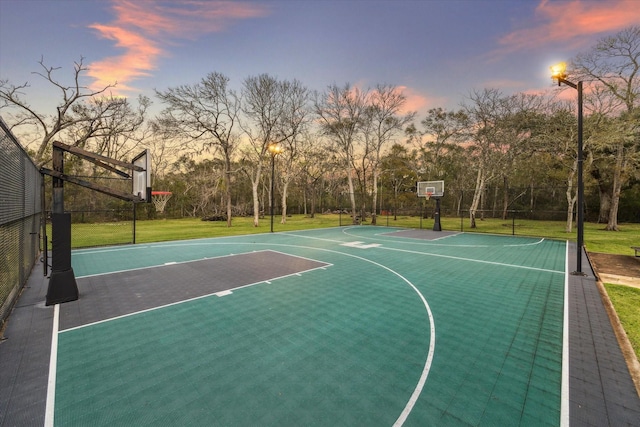 view of basketball court featuring a yard