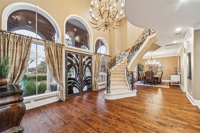 entrance foyer featuring wood-type flooring and ornamental molding