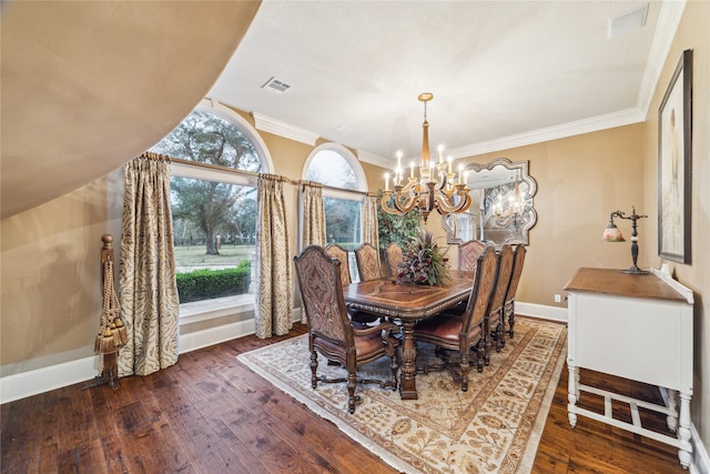 dining room with crown molding, dark hardwood / wood-style floors, and an inviting chandelier