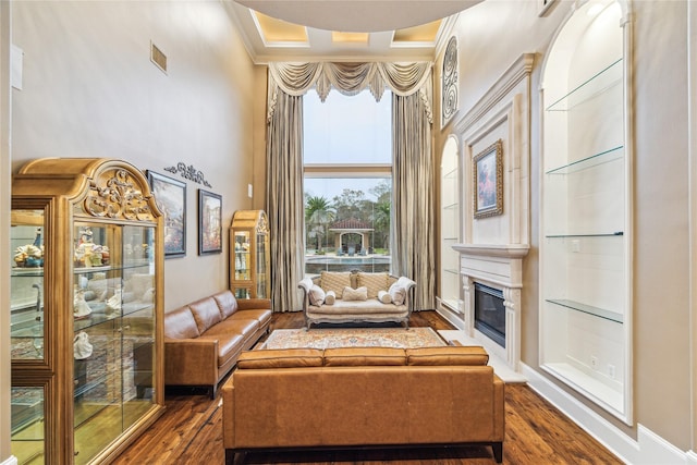 unfurnished living room with dark hardwood / wood-style flooring and a raised ceiling