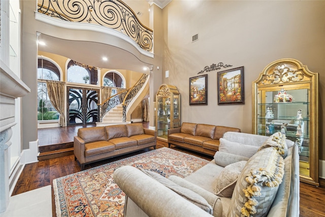 living room with dark hardwood / wood-style flooring and a high ceiling