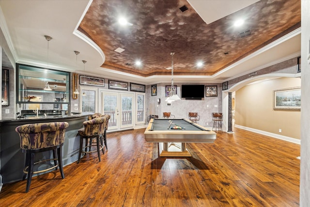 rec room featuring wood-type flooring, ornamental molding, billiards, and a tray ceiling