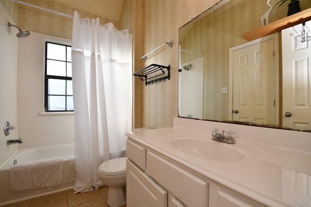 full bathroom featuring tile patterned flooring, vanity, toilet, and shower / bath combo with shower curtain