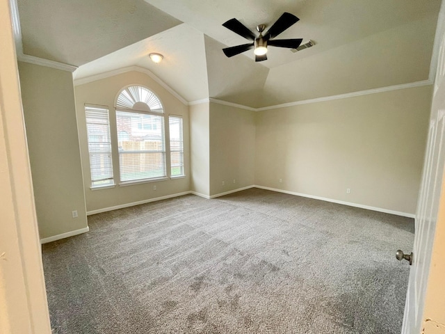 spare room with carpet, crown molding, ceiling fan, and lofted ceiling