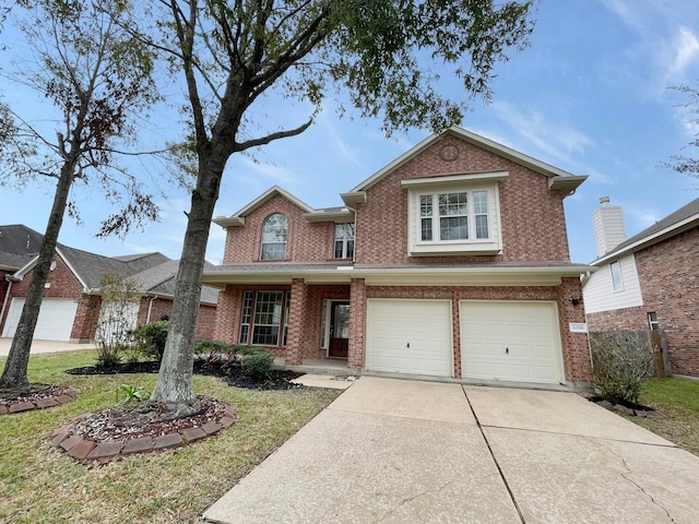 view of property with a front yard and a garage