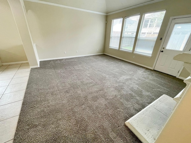 unfurnished living room with carpet floors, vaulted ceiling, and ornamental molding