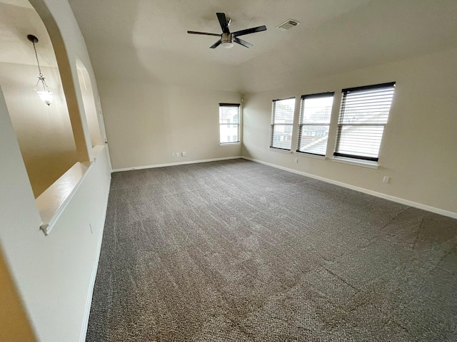 carpeted spare room featuring ceiling fan