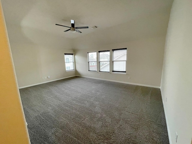 unfurnished room featuring ceiling fan and dark carpet