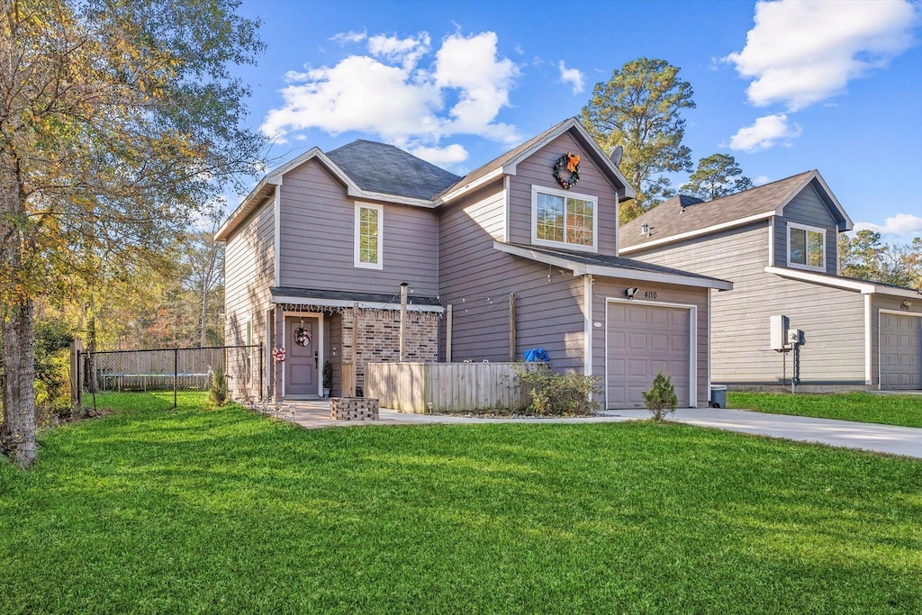 front facade featuring a front yard and a garage