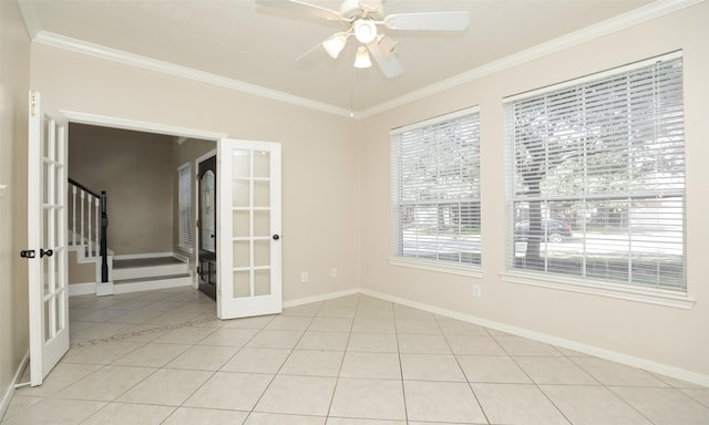 tiled spare room with ceiling fan, crown molding, and french doors