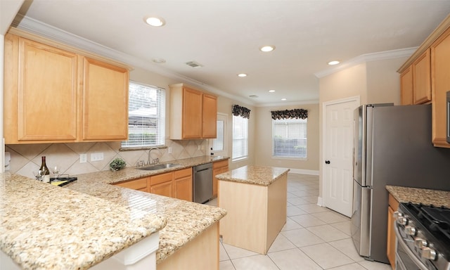 kitchen with light stone countertops, sink, a center island, decorative backsplash, and appliances with stainless steel finishes