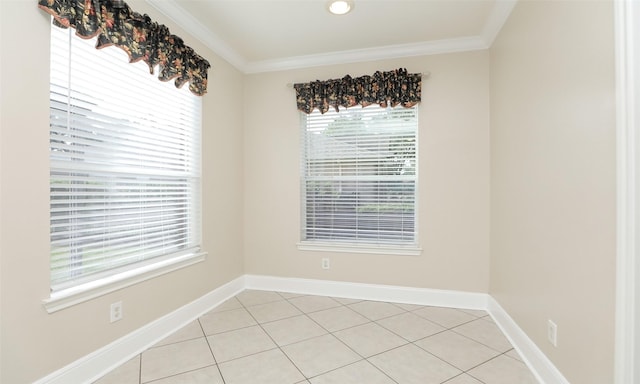 tiled spare room with a wealth of natural light and ornamental molding