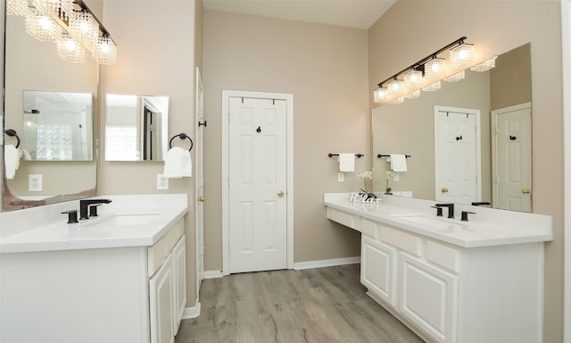 bathroom featuring an inviting chandelier, vanity, and hardwood / wood-style flooring