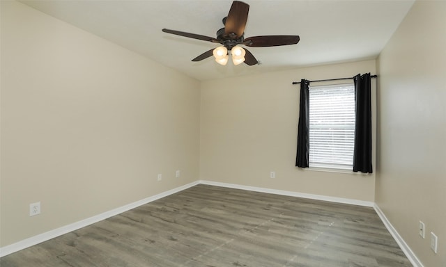 spare room with ceiling fan and light wood-type flooring