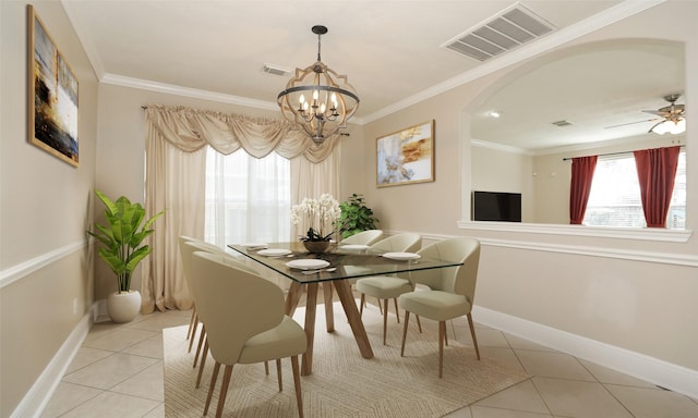 dining area with light tile patterned floors, ceiling fan with notable chandelier, and ornamental molding