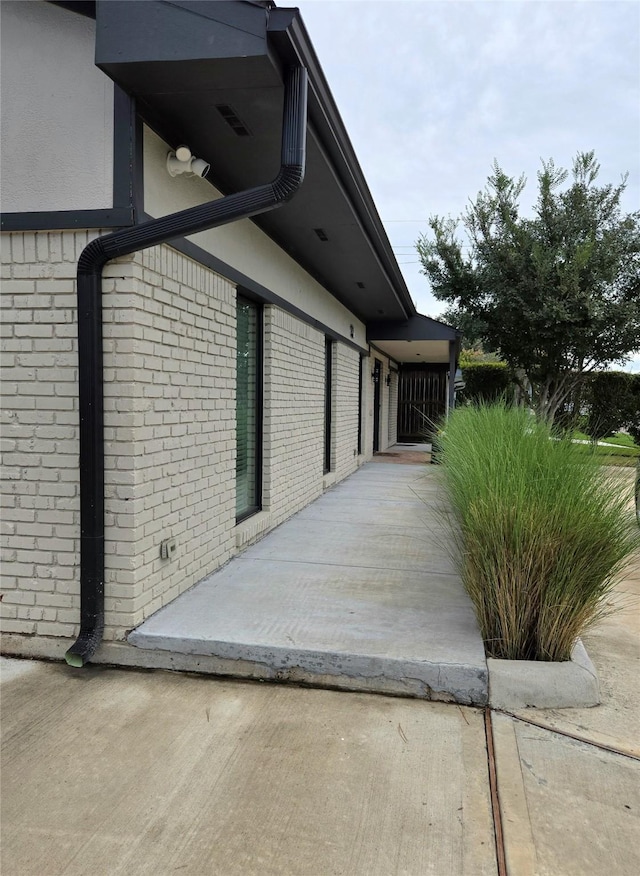 view of side of property featuring brick siding