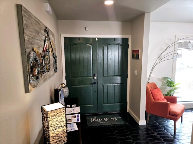 foyer entrance with recessed lighting and baseboards