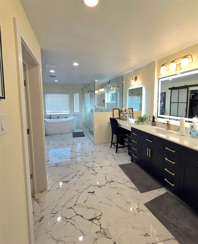 bathroom with a stall shower, marble finish floor, a freestanding bath, and vanity