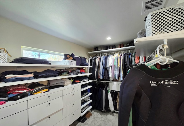 walk in closet featuring light carpet and visible vents