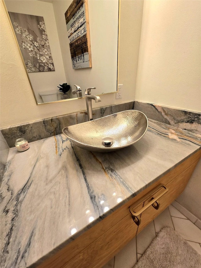 bathroom with tile patterned flooring and a sink