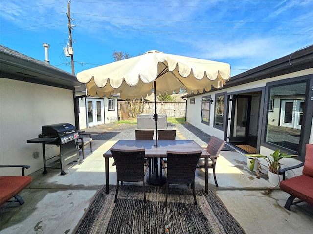 view of patio / terrace with outdoor dining space, fence, grilling area, and french doors