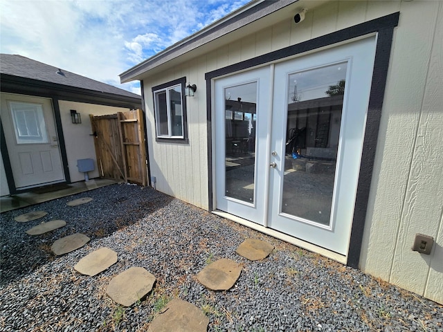 entrance to property with fence and french doors