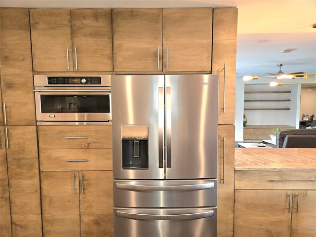 kitchen featuring wooden counters and appliances with stainless steel finishes