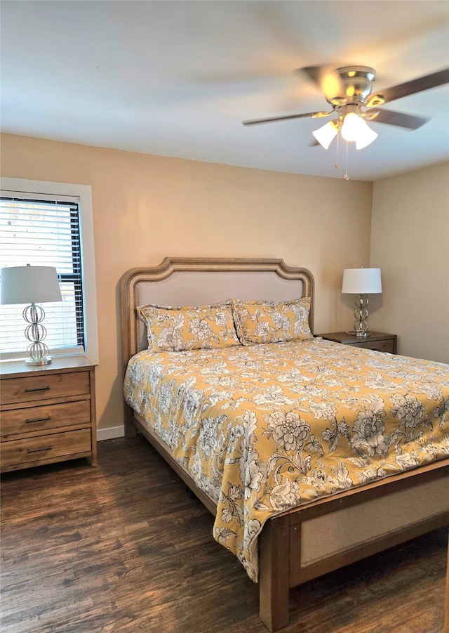 bedroom featuring ceiling fan, dark wood finished floors, and baseboards