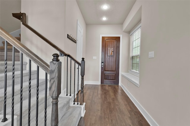 entrance foyer with dark wood-type flooring and a textured ceiling