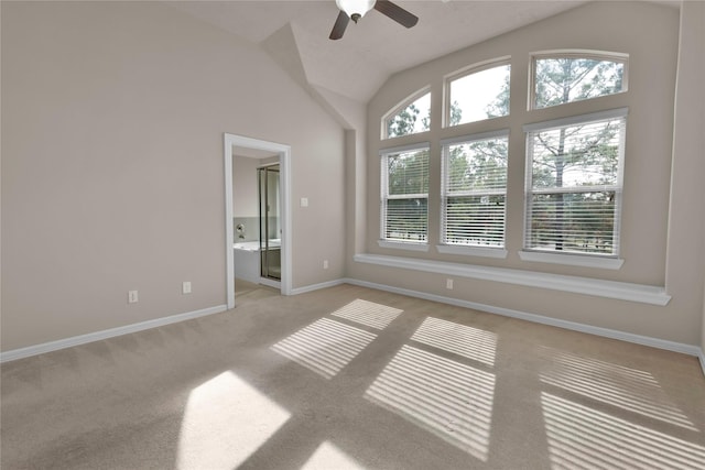 carpeted spare room with ceiling fan and lofted ceiling