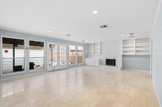 unfurnished living room featuring a textured ceiling, light tile patterned floors, and a fireplace