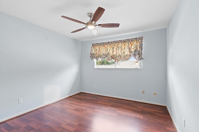 empty room featuring ceiling fan and dark hardwood / wood-style floors